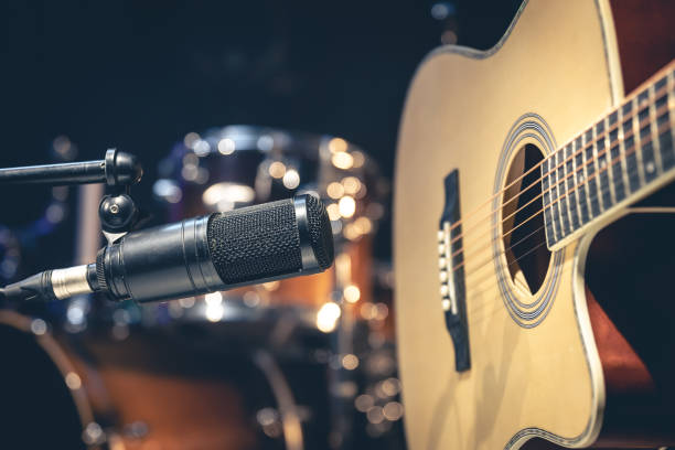 istock Acoustic guitar and microphone, recording in a music studio. 1484921023