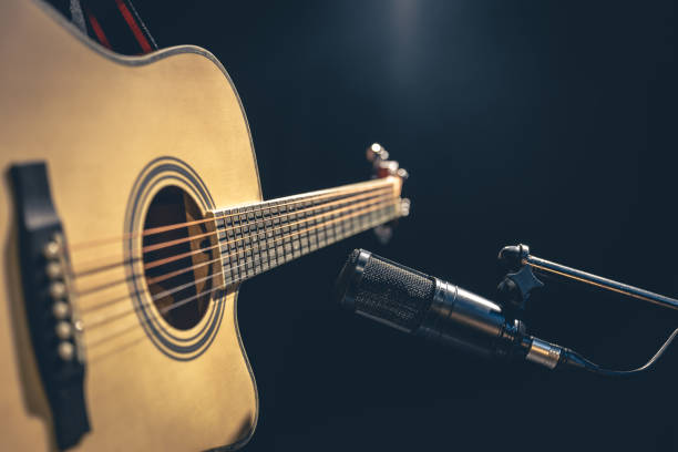 istock Acoustic guitar and microphone, recording in a music studio. 1484921034