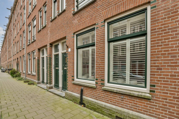 istock a brick building with green windows and a brick sidewalk 1484927574