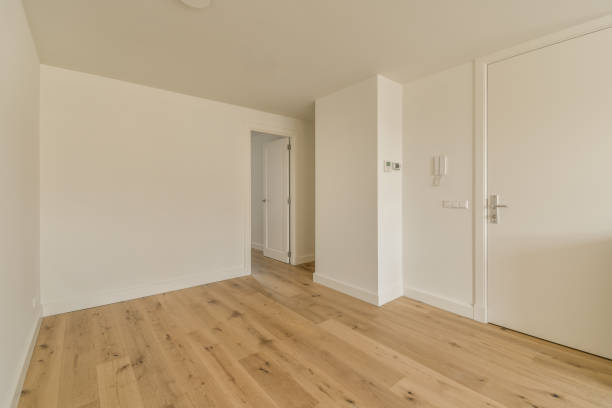 istock an empty room with wood floors and white walls 1484927943