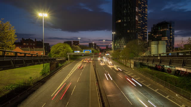 Road traffic on Mancunian way and Ring Road in Manchester city centre at dusk, England  - 4k time lapse