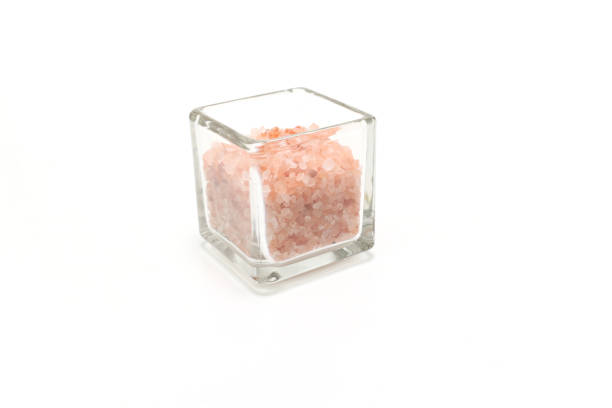 Rock solts in a glass cube isolated on a white background.