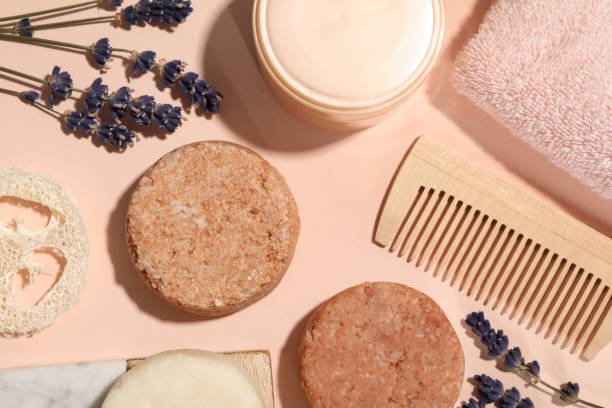 istock Flat lay composition of solid shampoo bars, lavender and comb on pink background. Hair care 1484933344