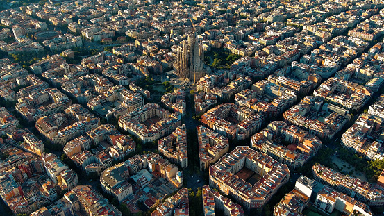 Aerial view of Barcelona Eixample residential district and famous Basilica Sagrada Familia at sunrise. Catalonia, Spain