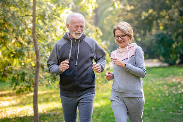 istock Cheerful active senior couple jogging in the park 1484935245