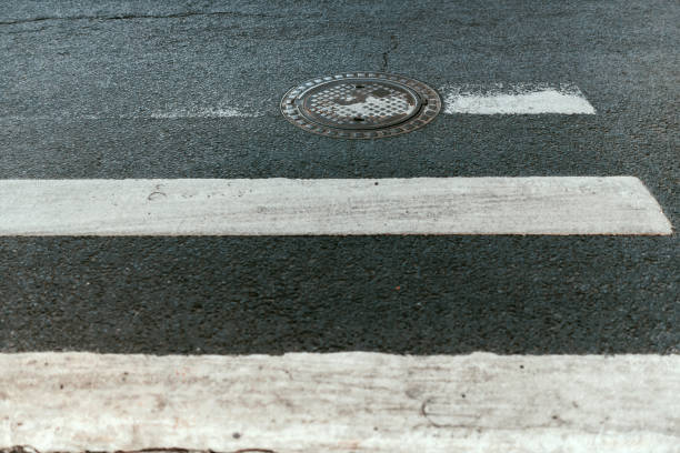 istock Manhole cover with pedestrian crossing markings. 1484935663