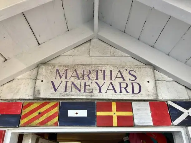 Martha's Vineyard sign on weathered building with dive flags