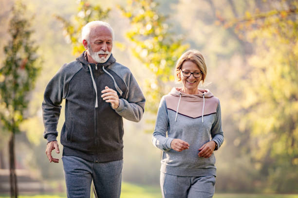 istock Cheerful active senior couple jogging in the park 1484936275