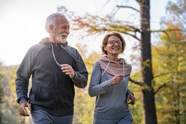 istock Cheerful active senior couple jogging in the park 1484936446
