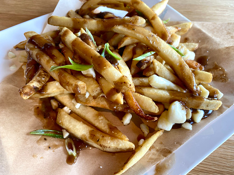 Poutine, a dish of French fries and cheese curds topped with a brown gravy