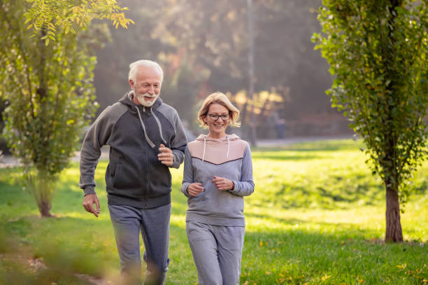 istock Cheerful active senior couple jogging in the park 1484936531