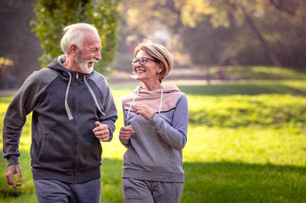 istock Cheerful active senior couple jogging in the park 1484936533