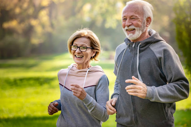 istock Cheerful active senior couple jogging in the park 1484936543