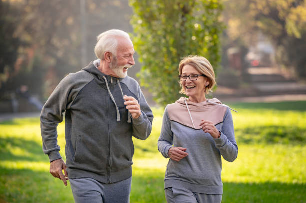 istock Cheerful active senior couple jogging in the park 1484937028