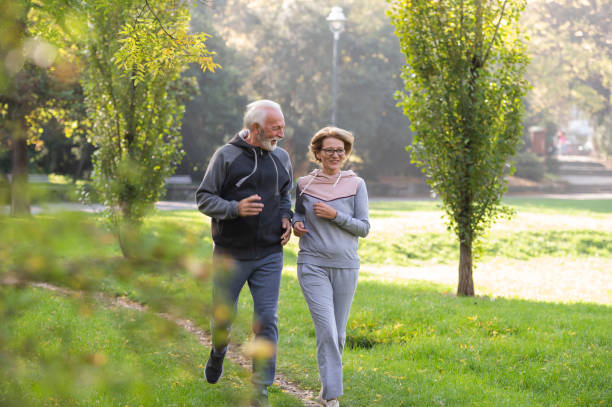 istock Cheerful active senior couple jogging in the park 1484937889