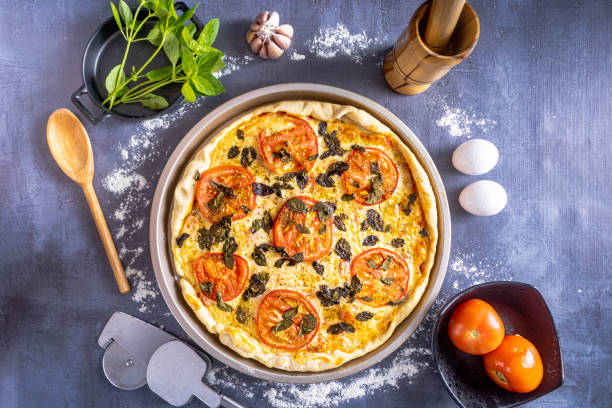 istock Delicious margherita pizza with basil, garlic, tomatoes, eggs. On black background. 1484938679