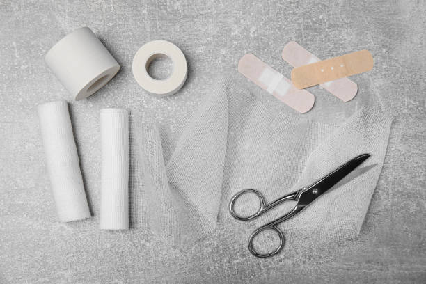 istock White bandage rolls and medical supplies on light grey table, flat lay 1484940872