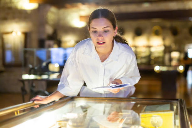 istock Woman looking at the exposition of mediaeval boxes 1484945692