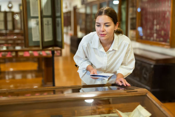 istock Young woman with information booklet visiting museum 1484945705