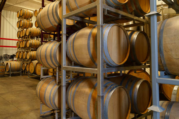 istock Wine Barrels Stacked in a Warehouse 1484947145