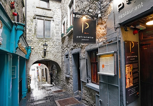 Kilkenny, Ireland - March 2023: Medieval passageway called Butterslip Lane in Kilkenny, with a restaurant named after a woman executed for witchcraft