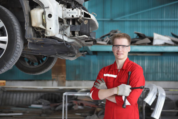 istock Auto mechanic working in garage. Repair service.checking engine and trailing 1484948669