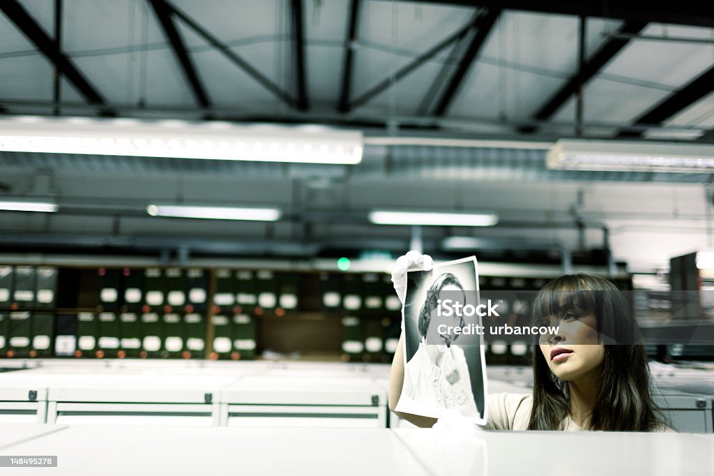 Hulton Archive researcher A woman handling pictures from the Hulton Archives, wearing white gloves. Archives Stock Photo