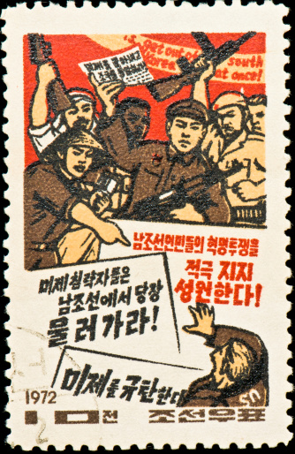 North Korean postage stamp with people rioting with banners and arms in hand.