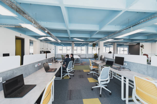 istock Photo of a modern office where programming, digital marketing and web design projects are done. Office with modern furniture and glass office 1484953518