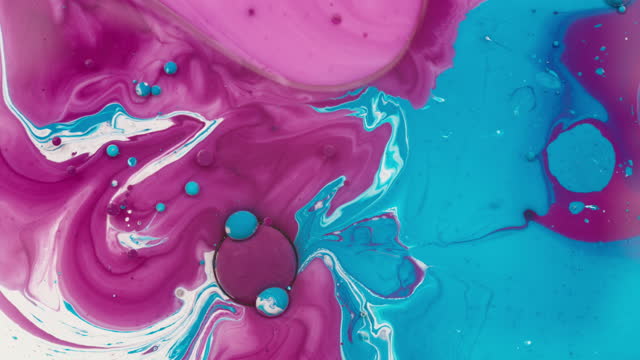 Abstract background of pink and blue colors swirling in liquid