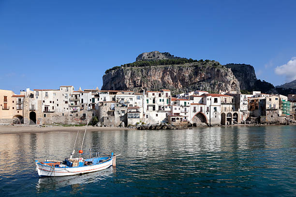 Rowboat, Old Buildings and mountain at Cefalu Beach Italy Rowboat, Old Buildings and mountain at Cefalu Beach Italy. cefalu stock pictures, royalty-free photos & images