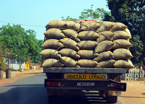 Safim Sector, Biombo Region, Guinea-Bissau: truck heading for Bissau harbor, fully loaded with burlap sacks filled with raw cashew nuts, the country's main export. Harvesting cashew is the most dominant economic activity among Bissau-Guinean households.