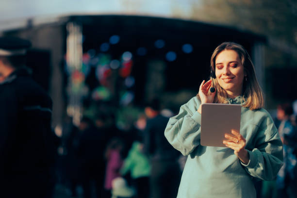 Music Festival Organizer Wearing a Headset Holding a Pc Tablet