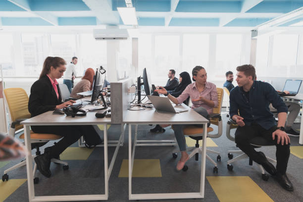 istock Collaborative process of multicultural skilled young business team during brainstorming meeting in office.Diverse group of young people dressed in formal wear cooperating on developing design project 1484958959