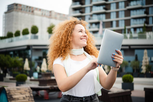 istock Portrait of a beautiful redhead girl on a coffee break using tablet 1484959159