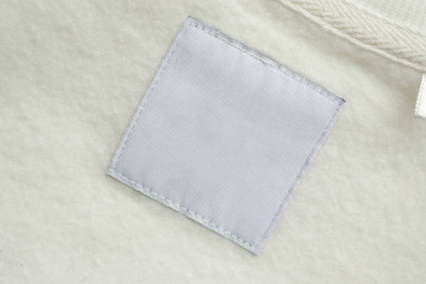 istock Blank white laundry care clothes label on fabric texture background 1484959245