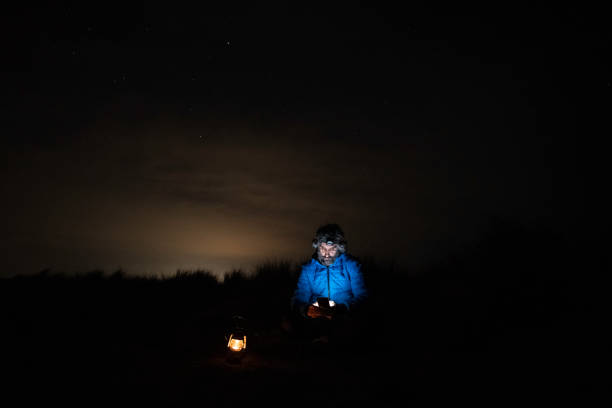 istock People in nature. Man with phone at night at seaside. copy space 1484959431
