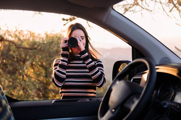 istock woman taking photos with camera during a road trip 1484959465