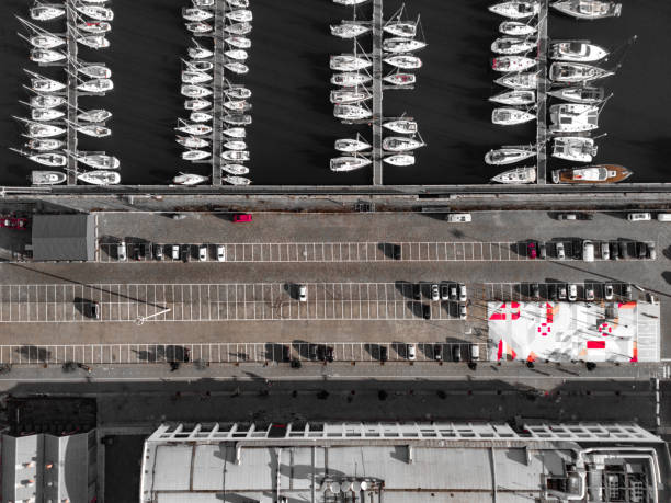 Aerial images of dock with parked boats side by side  of a car parking Aerial perspective of dock with recreation boats aligned and tied to the pontoon parallel port stock pictures, royalty-free photos & images