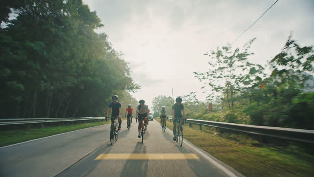 group Asian Chinese Cyclist sprinting cycling in rural area during weekend morning