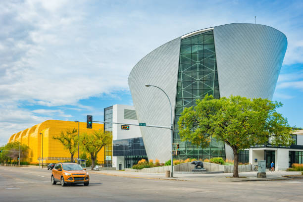 Car drives past buildings on the University of Alberta campus in Edmonton Canada on a cloudy day.