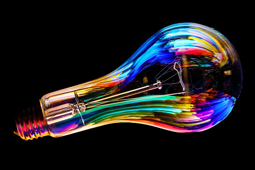A colorfully illuminated lightbulb