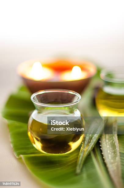 Spa Oil On Leaf With Aloe And Lit Candle Stock Photo - Download Image Now - Aloe, Alternative Therapy, Aromatherapy