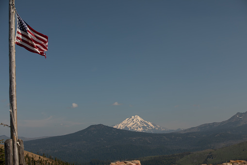 Located at an outpost in Central Oregon, a view of Mount Hood on a clear day. This hike had an American flag blowing in the wind, as you get to admire the view of the mountain. This photo was taken just before Independence Day.