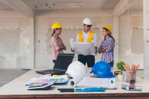 istock Civil construction engineer team meeting on construction site with teamwork wear safety suit trust team look at blue print on table consulting together safety hard hat construction engineer concept 1484979197