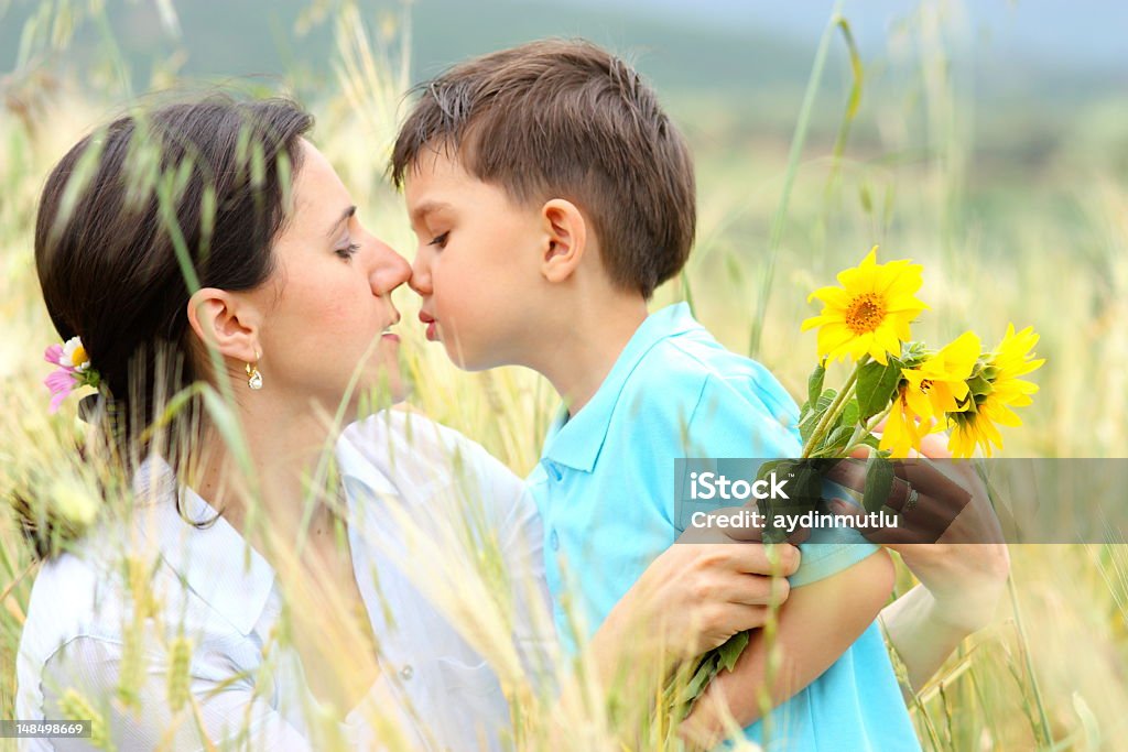 Mother and son Mother and son kissing. Adult Stock Photo