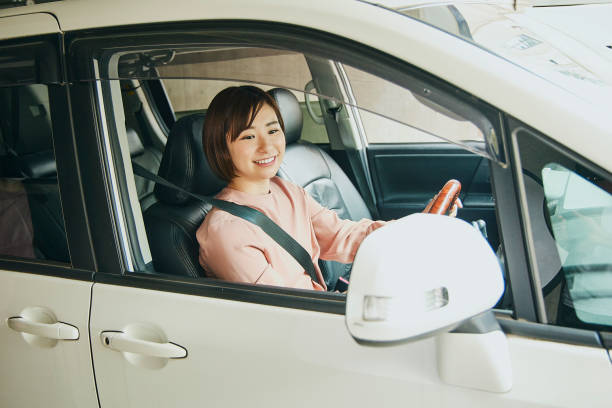 istock Woman in pink and driving a white car. 1484987049