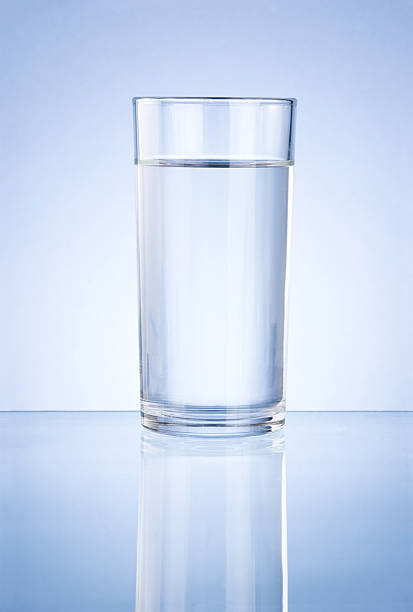 istock Glass of water on blue background 148499008