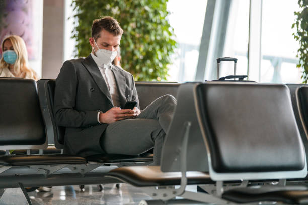 istock Businessman At The Airport Using A Smartphone 1484996355