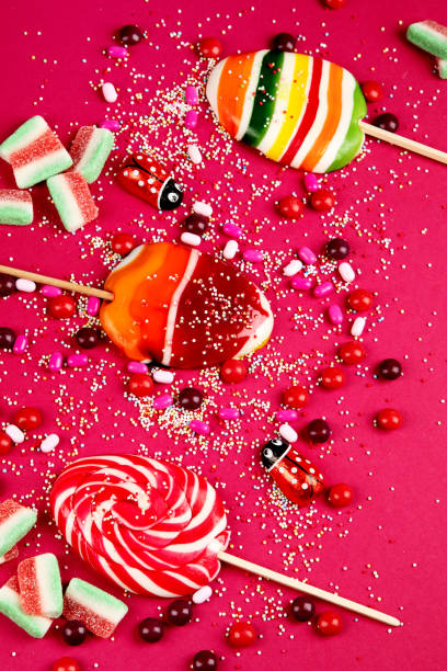 Mixed collection of colorful candy, on pink background. Top view.